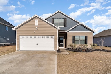 View of front facade featuring board and batten siding, concrete driveway, and a garage