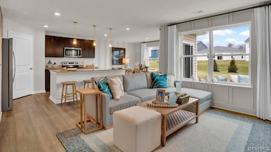 Living room with light hardwood / wood-style floor