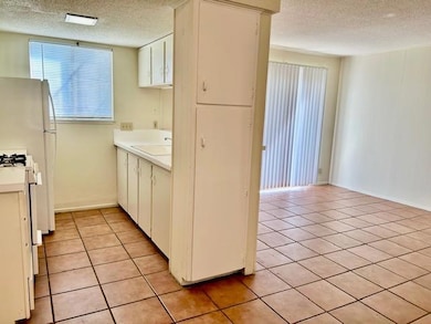Kitchen featuring light countertops, range with g