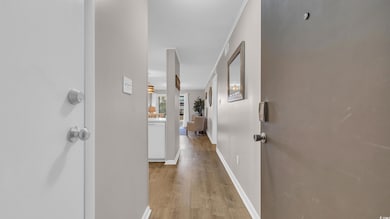 Hall with light wood-style floors and baseboards