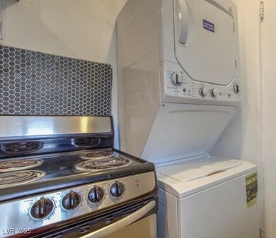 Laundry area with estacked washer and dryer