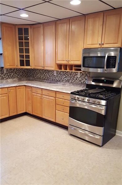 Stainless Gas Stove and Microwave w/ new tiled bac