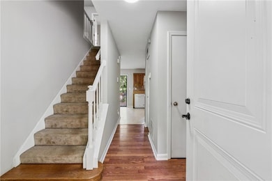 Stairway featuring wood finished floors