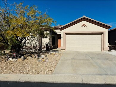 Ranch-style home featuring stucco siding, a tiled roof, concrete driveway, and a garage