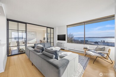 Custom steel and glass partition adds an artful design to the sprawling living area and provides a beautiful separation of space.