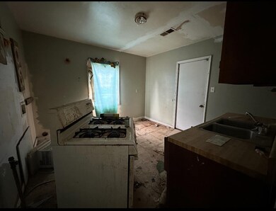Kitchen featuring a sink and white gas stove