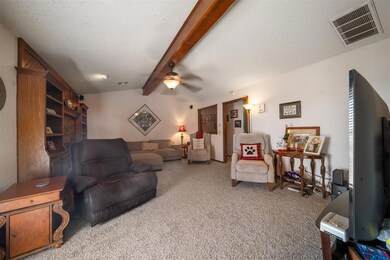 Living room with lofted ceiling with beams, ceilin