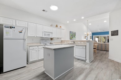Kitchen featuring visible vents, a center island, 