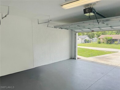 Garage featuring a garage door opener and a textur