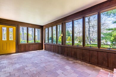 Large sunroom with wall of windows