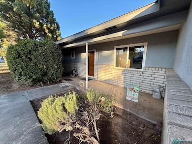 Entrance to property featuring brick siding and stucco siding