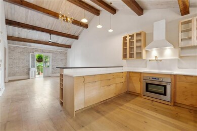 Exposed beams with Raised ceilings and an artists