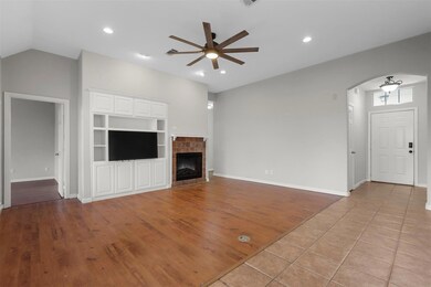 Unfurnished living room featuring built in shelves