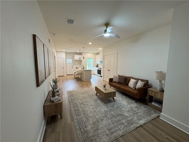 Living room with visible vents, baseboards, ceilin