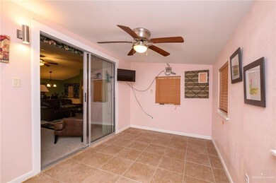 Spare room featuring baseboards, ceiling fan, vaulted ceiling, and tile patterned floors