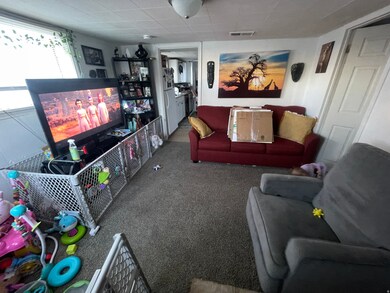 Carpeted living area with a drop ceiling