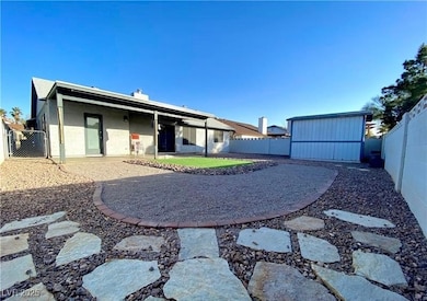 Back of property with a fenced backyard, a shed, a