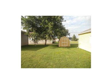 Yard. Flat and has storage shed