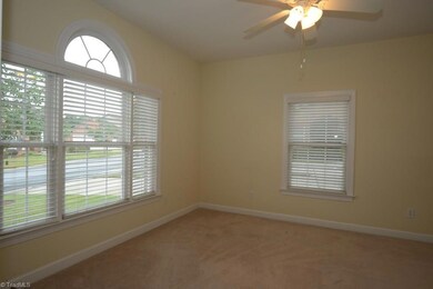 Bedroom 2 is located to the left of the front entry, with double french doors connecting the room to the foyer.