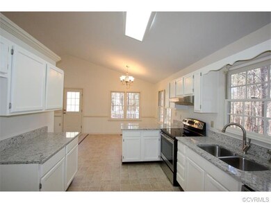 Kitchen features granite countertops, a large doub