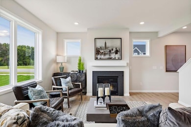 Main floor includes cosmo-style gas fireplace (not shown); and abundance of windows. Photos taken from model of similar floor plan. Photos may not depict actual home plan configuration. Features/materials/finishes shown contain options not included.