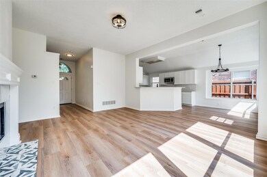 Unfurnished living room featuring light hardwood /