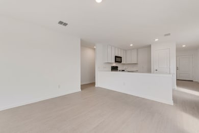 Unfurnished living room featuring light wood finished floors and recessed lighting