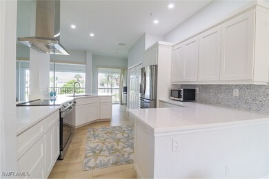 Kitchen featuring kitchen peninsula, white cabinet