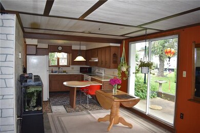 Kitchen and dining area features a sliding glass d