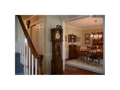 Classic center hall entry with the FormalDining room to right and Living Room (not in photo) to left. Note hardwood, paneled doors,  molding and wainscoting - all in pristine condition.