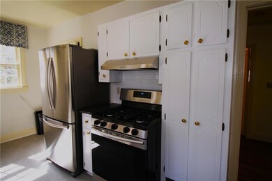 Kitchen featuring white cabinetry, under cabinet r