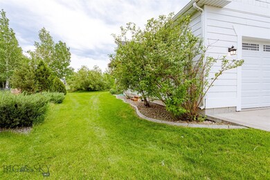 Side yard to left of garage.