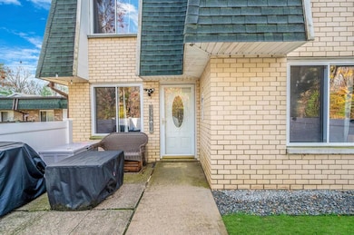 View of exterior entry with brick siding
