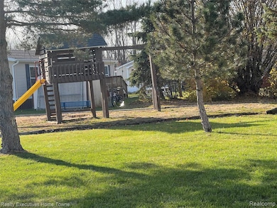 Community jungle gym featuring a lawn and a deck