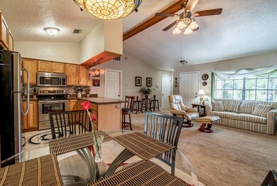 Dining area towards living area and kitchen.
