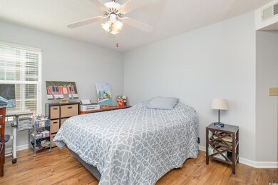 Bedroom featuring a ceiling fan, baseboards, visib
