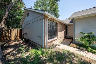 View of property exterior with brick siding, fenc