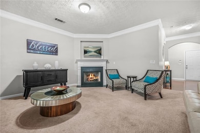 Sitting room with arched walkways, ornamental mold