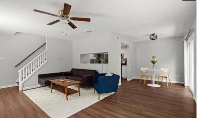 Living room featuring wood finished floors, stair