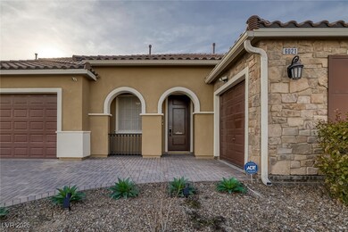 Doorway to property featuring stone siding, drivew