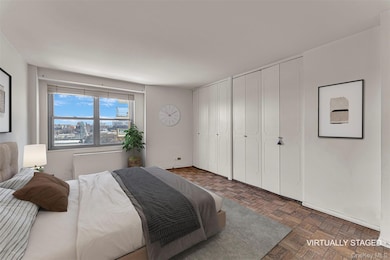 Bedroom featuring dark parquet flooring