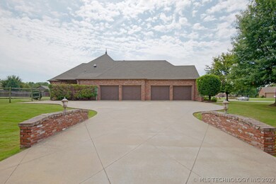 A north facing driveway features brick side walls