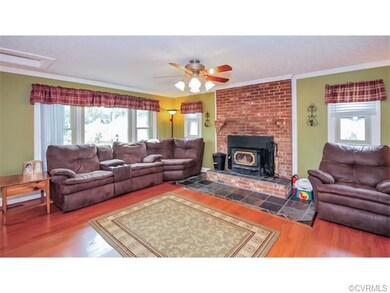 Family room features a brick fireplace with a wood