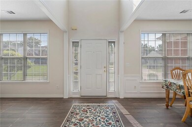 Entrance foyer with hardwood / wood-style flooring and healthy amount of natural light