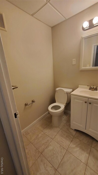 Bathroom with vanity and light tile patterned floors