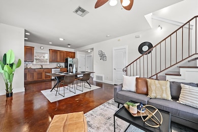 Living area featuring concrete floors, stairway, 