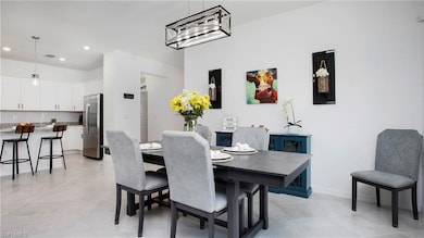 Dining area with recessed lighting, light tile patterned flooring, and baseboards