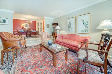 Neutral & bright living room opening to dining roo