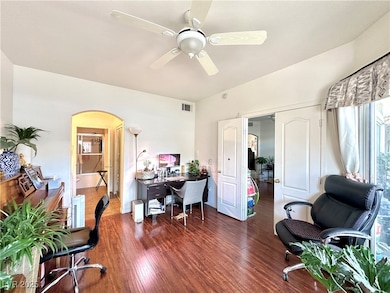 Office space featuring arched walkways, a ceiling