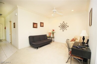 Living area with crown molding, light tile pattern